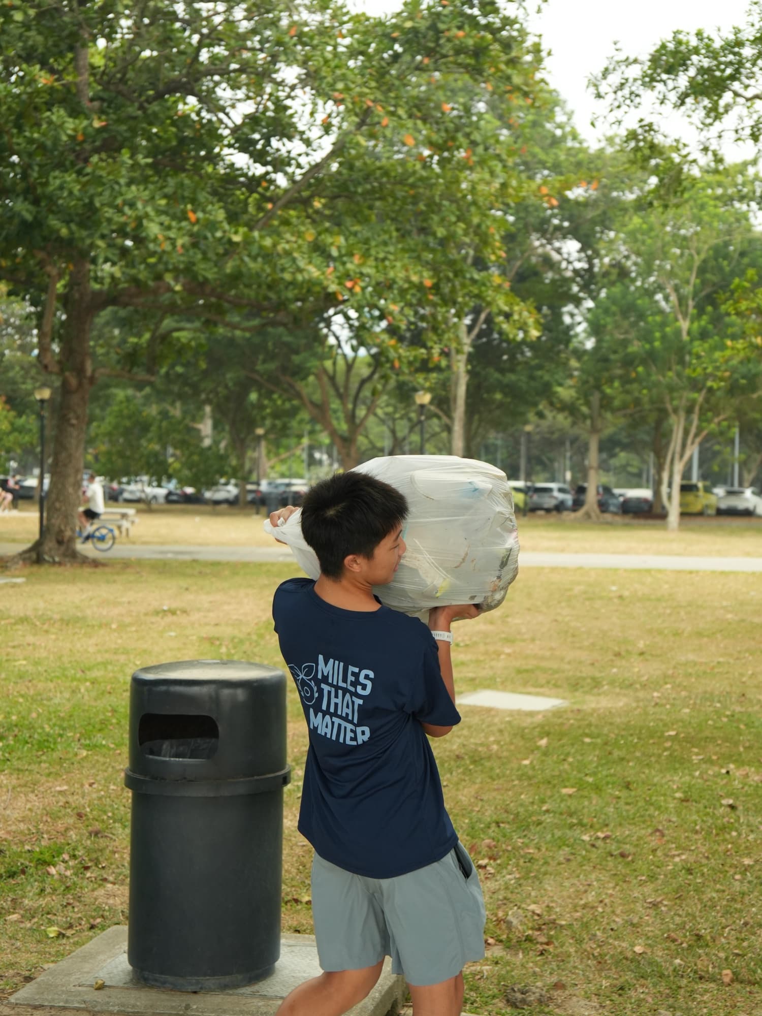 An EcoMiles plogger carrying a bag of collected waste