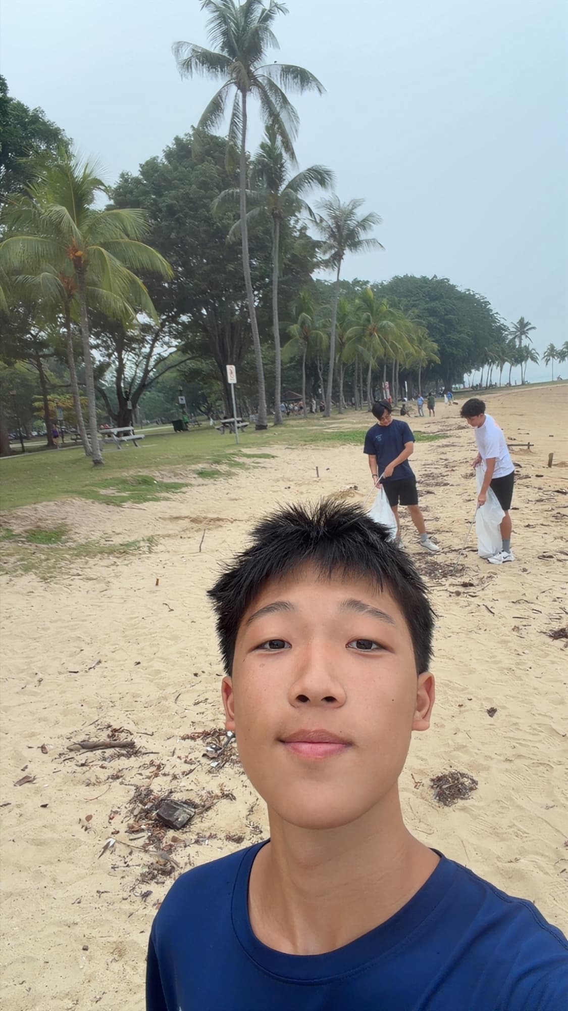 Sam at a beach cleanup with ploggers picking up litter