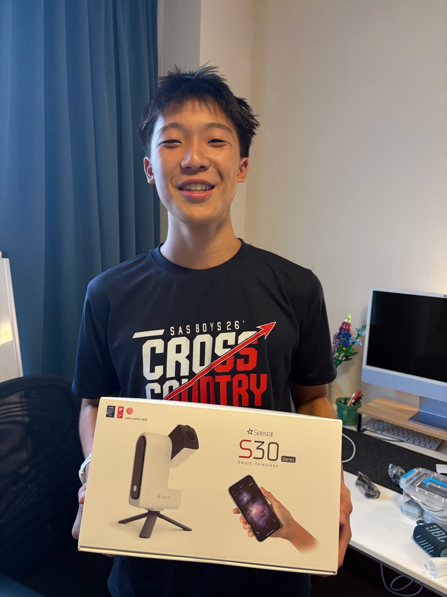Sam Chang holding a Seestar smart telescope