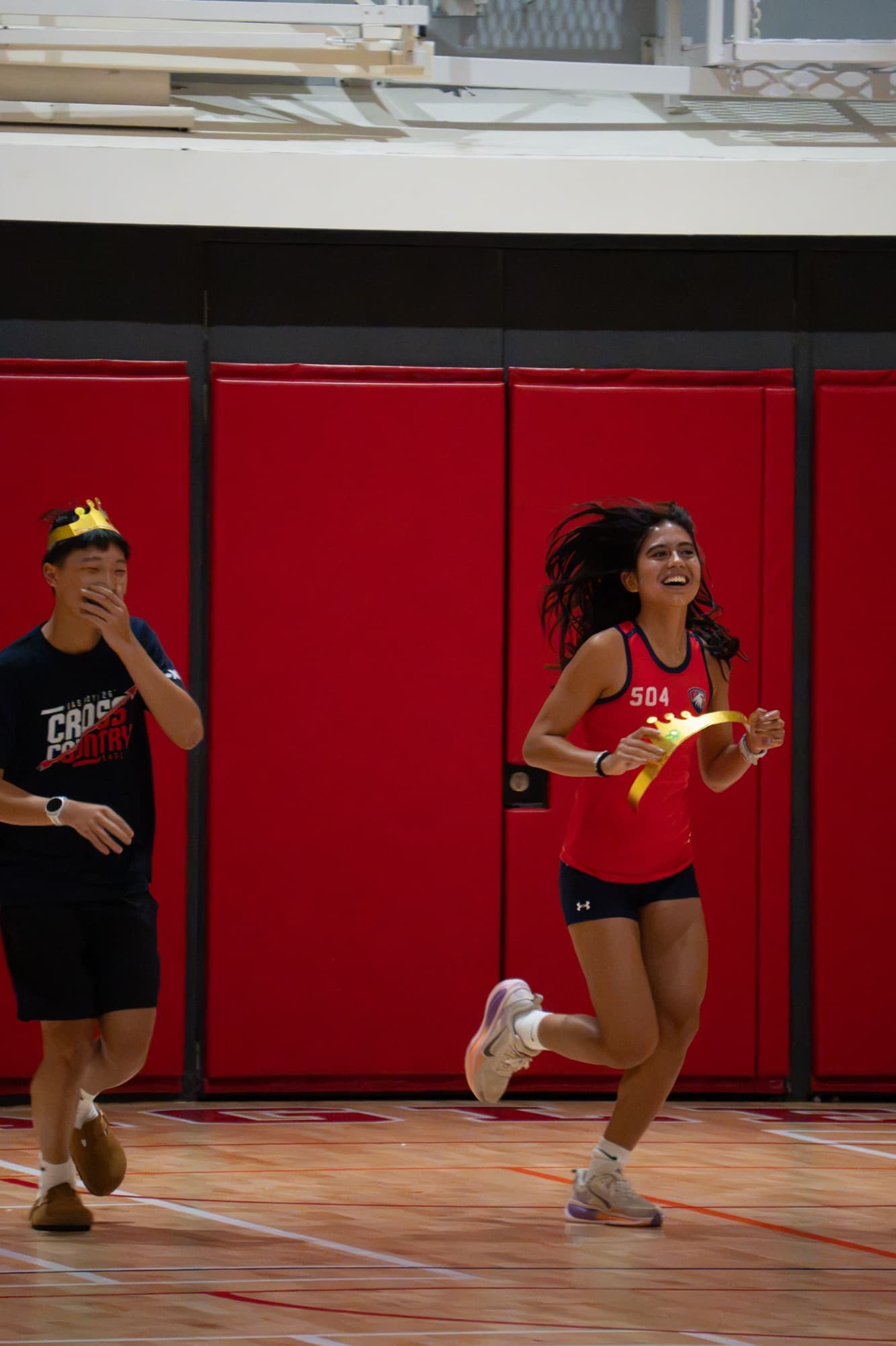 A teammate running a relay at the track banquet